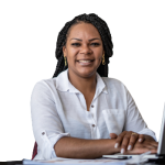 Smiling lady sitting at a desk with a laptop while folding her hands on the desk.